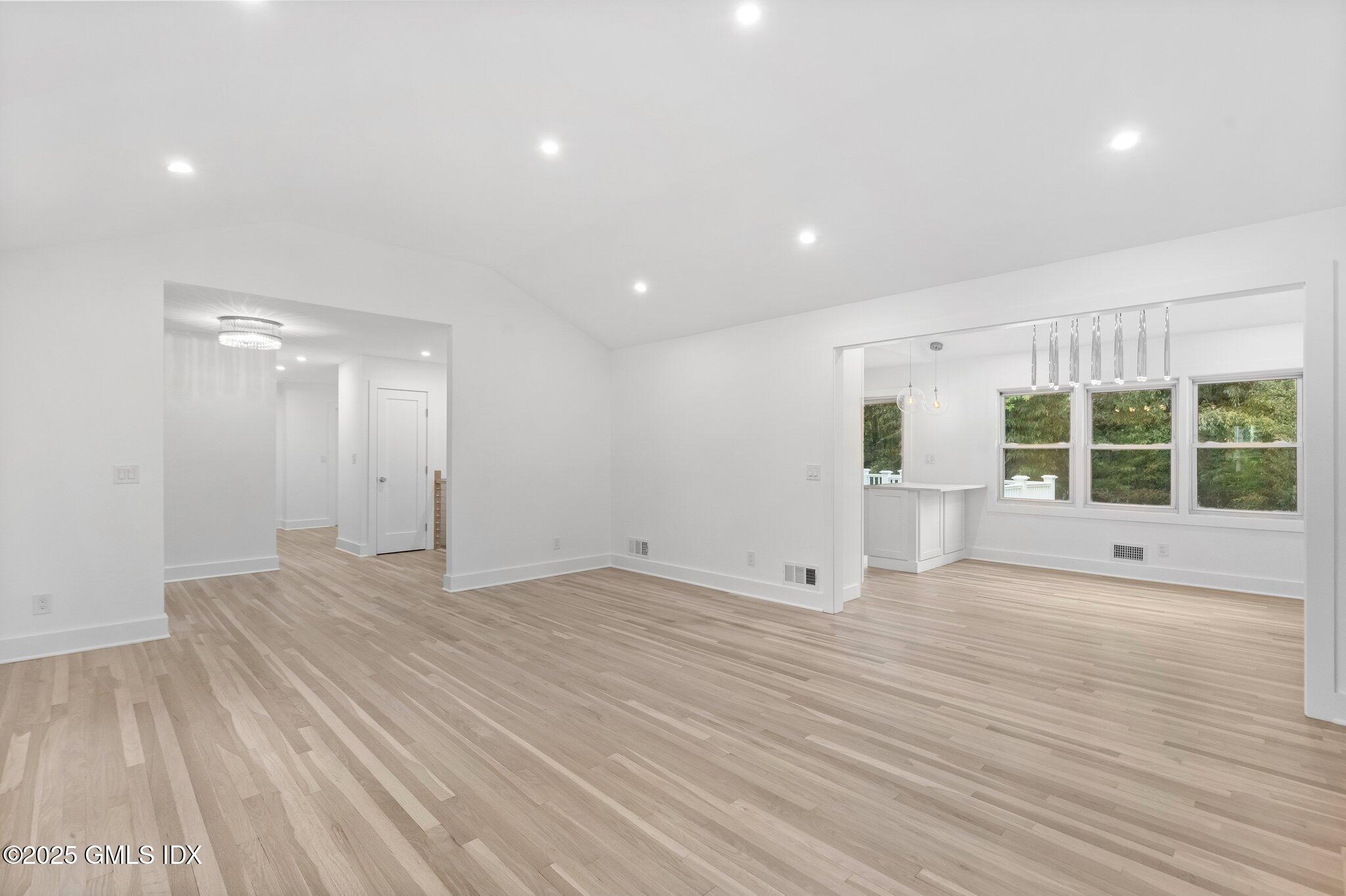 8 Pintail Lane Greenwich, CT 06830 - Photo 6 of 37 a view of an empty room with wooden floor and a window