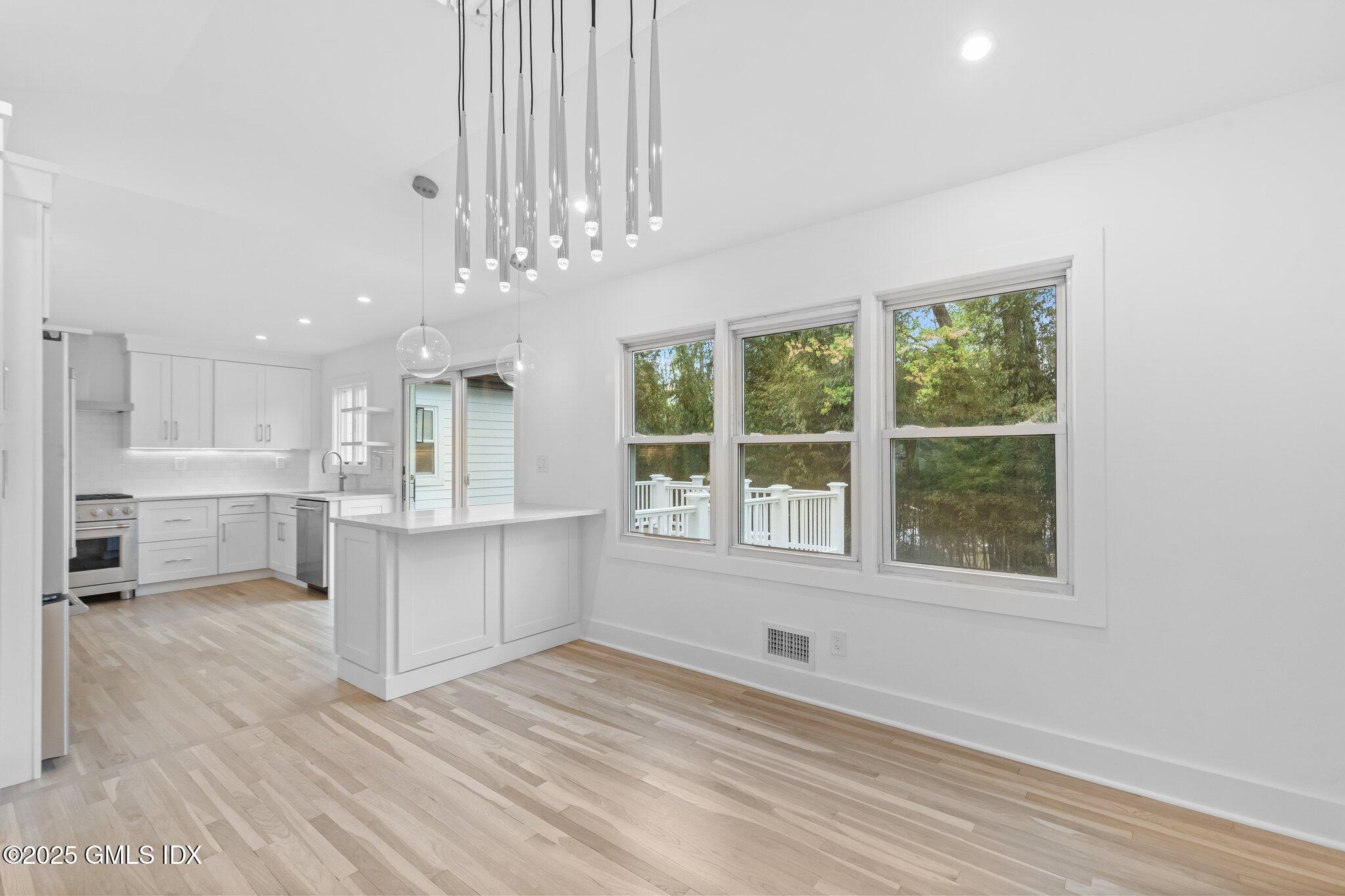 8 Pintail Lane Greenwich, CT 06830 - Photo 9 of 37 a view of kitchen with windows and ceiling fan