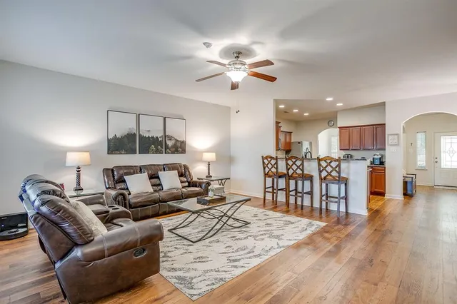 a living room with furniture and kitchen view