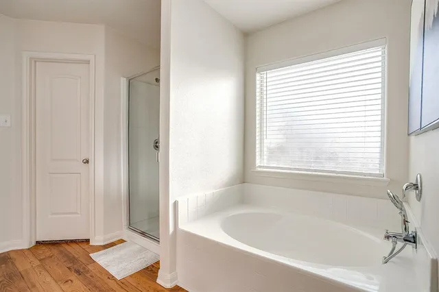 a bathroom with a bathtub and a window