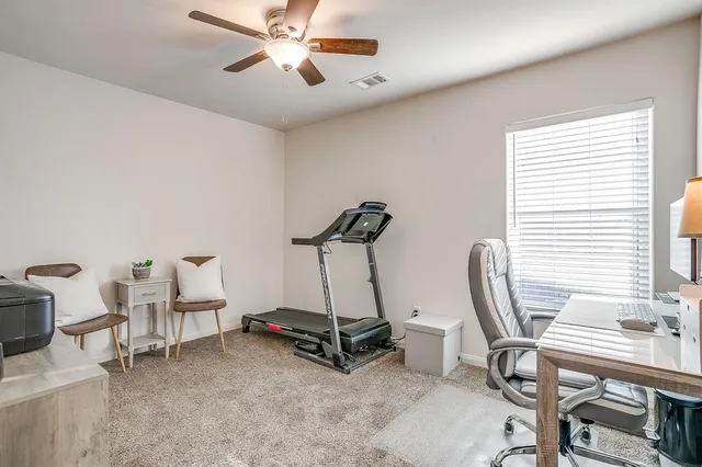 a room with gym equipment and windows
