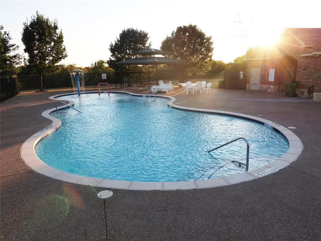 a view of a swimming pool with a yard