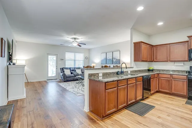 a kitchen with a sink cabinets and wooden floor