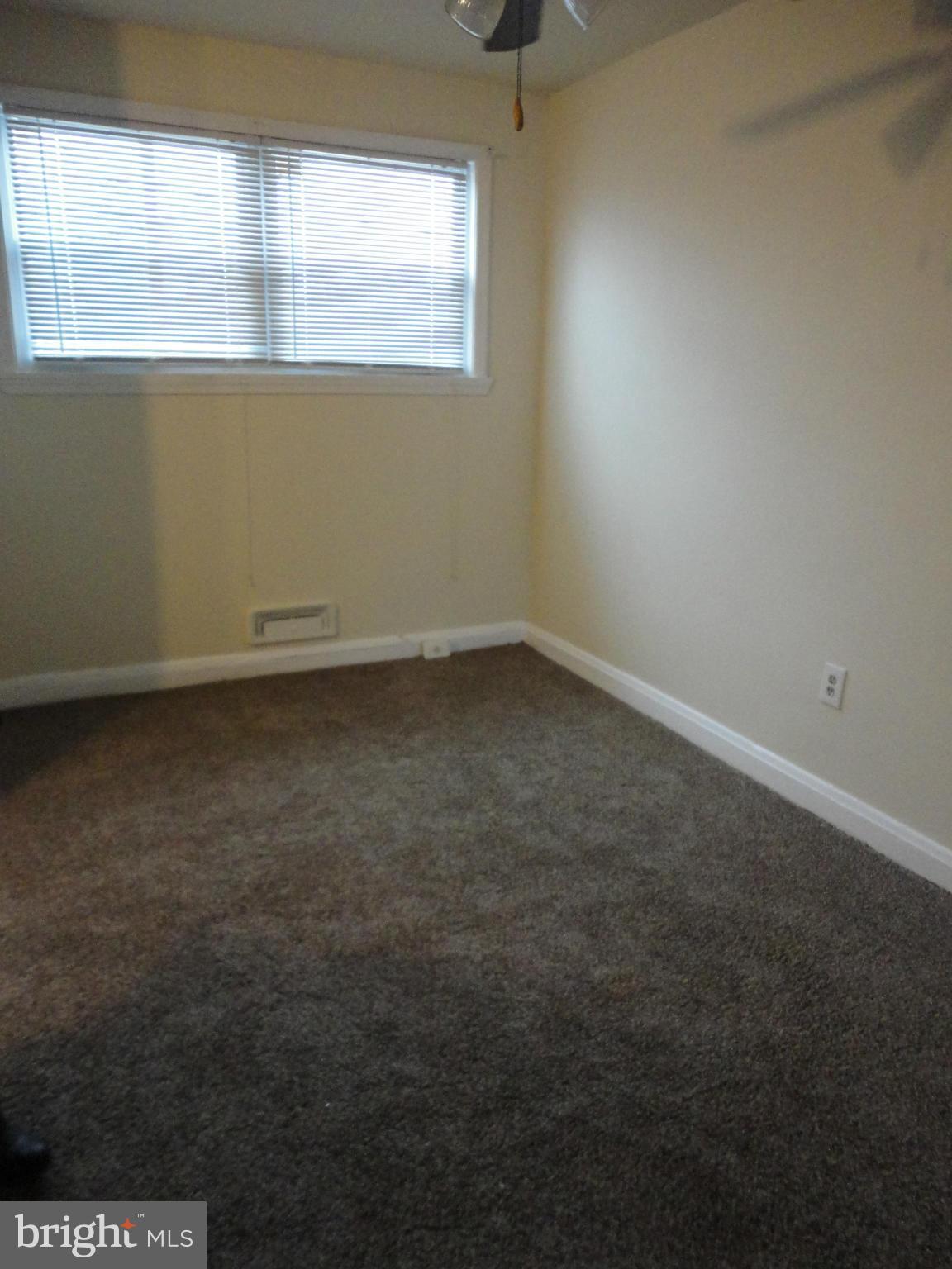 4903 Greencrest Road Baltimore, MD 21206 - Photo 8 of 26 an empty room with a window