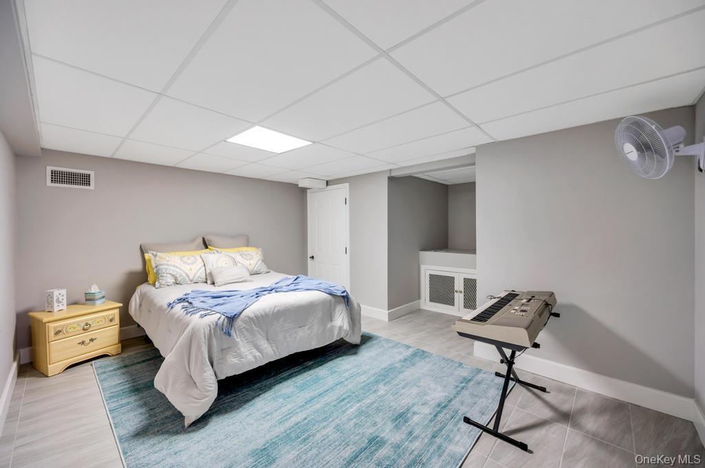 10 South Lot Road Smithtown, NY 11787 - Photo 34 of 50 Neutral-toned room featuring a drop ceiling with recessed lighting