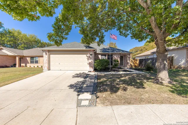 a front view of a house with a yard and a garage