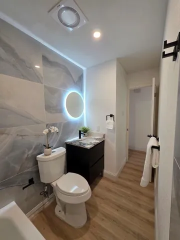 an empty room with a ceiling fan and window