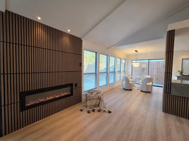 a dining room with furniture a chandelier and wooden floor