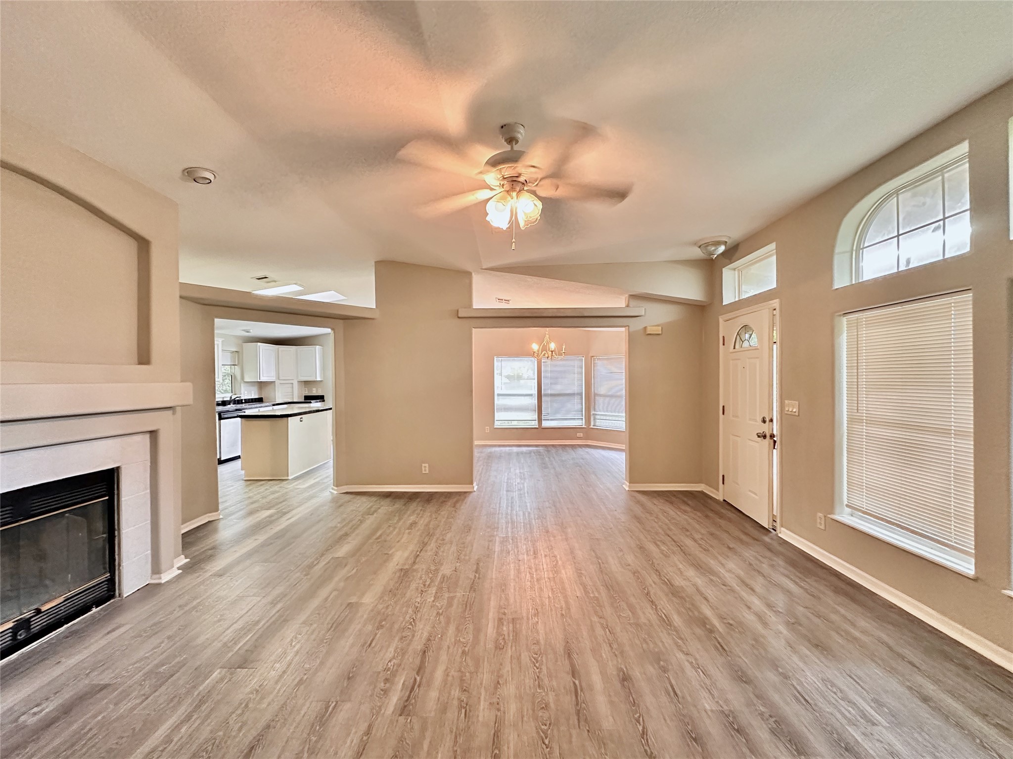 202 Main Street Fresno, TX 77545 - Photo 7 of 26 a view of empty room with wooden floor and fireplace