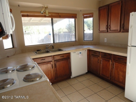 5730 North Ezybrook Road Tucson, AZ 85741 - Photo 3 of 10 a kitchen with a sink stove and cabinets