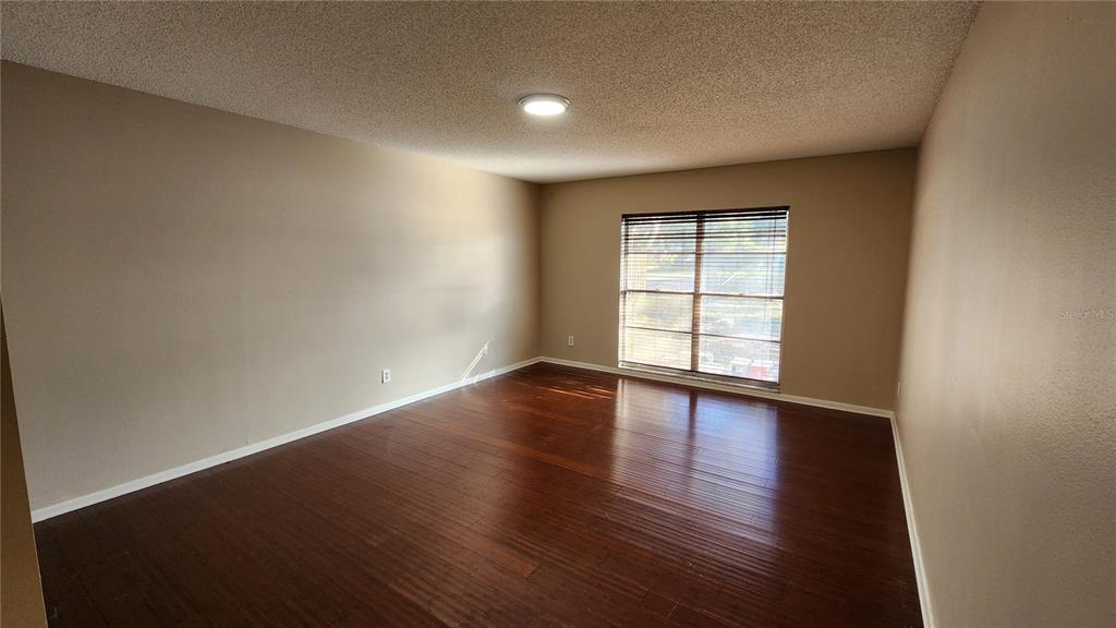 14921 Old Pointe Road Tampa, FL 33613 - Photo 11 of 32 a view of empty room with wooden floor and fan