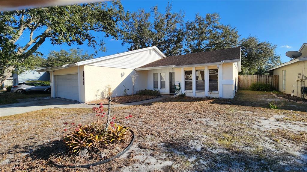 14921 Old Pointe Road Tampa, FL 33613 - Photo 2 of 32 front view of a house with a yard
