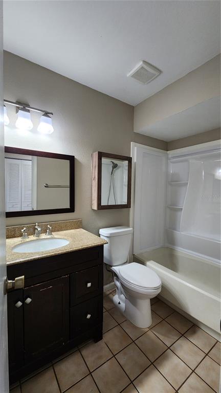 14921 Old Pointe Road Tampa, FL 33613 - Photo 23 of 32 a bathroom with a toilet sink and mirror