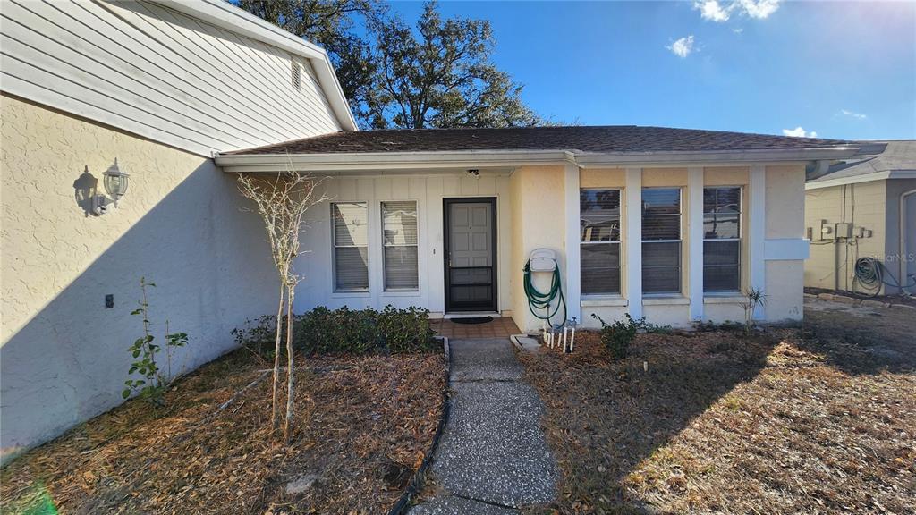 14921 Old Pointe Road Tampa, FL 33613 - Photo 3 of 32 a view of a brick house with large windows