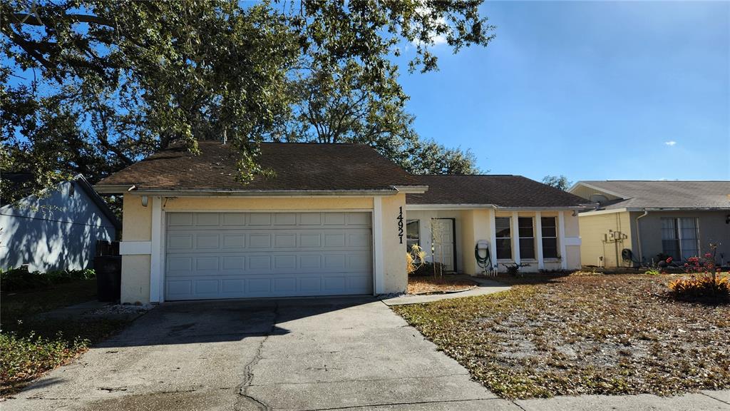 14921 Old Pointe Road Tampa, FL 33613 - Photo 32 of 32 a front view of a house with a yard