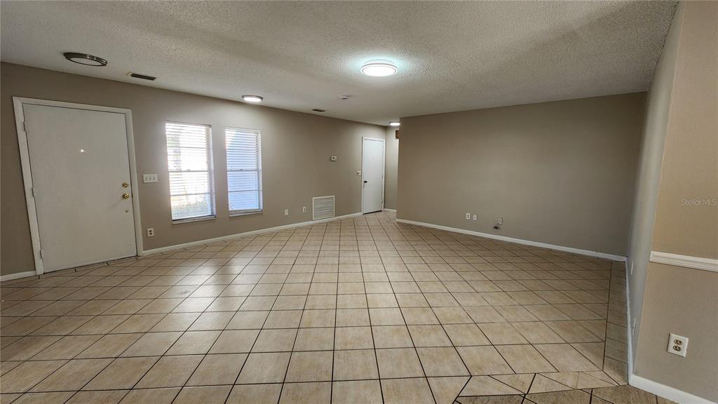 14921 Old Pointe Road Tampa, FL 33613 - Photo 4 of 32 a view of an empty room and window