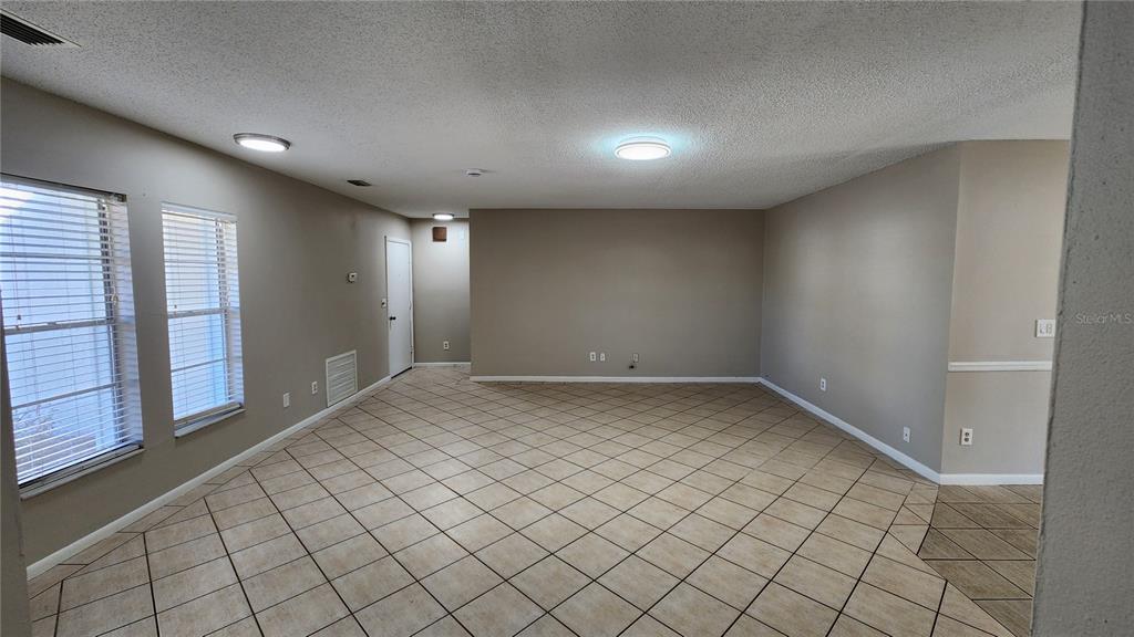 14921 Old Pointe Road Tampa, FL 33613 - Photo 5 of 32 an empty room with windows