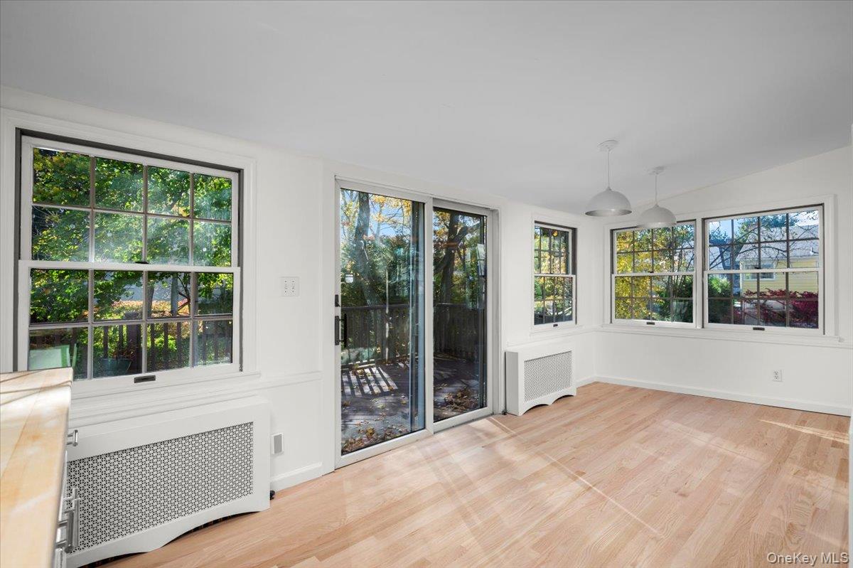 115 Coolidge Avenue Rye, NY 10580 - Photo 11 of 27 a view of an empty room with wooden floor and a window