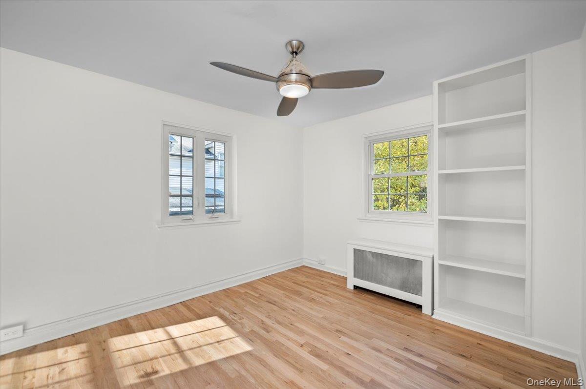 115 Coolidge Avenue Rye, NY 10580 - Photo 12 of 27 wooden floor in an empty room with a window