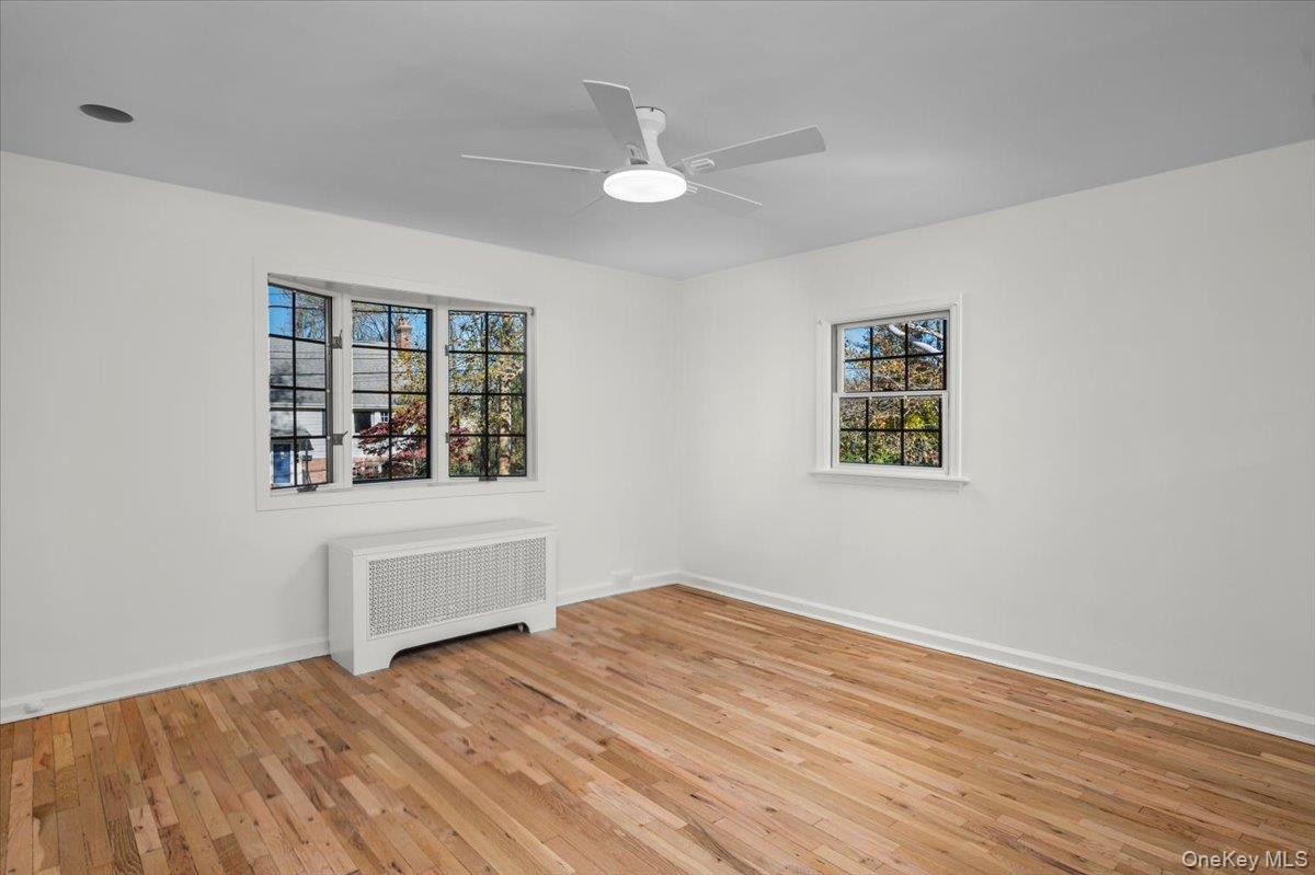 115 Coolidge Avenue Rye, NY 10580 - Photo 13 of 27 a view of empty room with wooden floor and fan