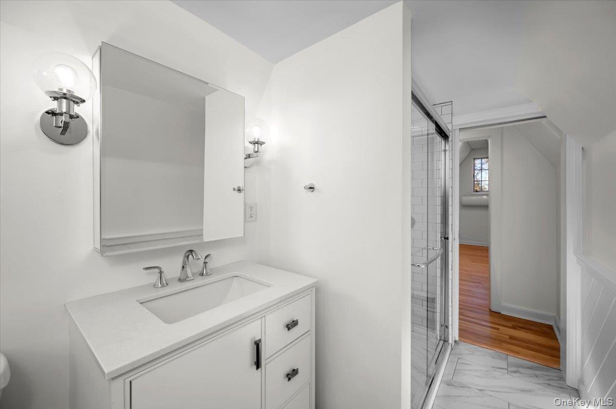115 Coolidge Avenue Rye, NY 10580 - Photo 20 of 30 a bathroom with a sink and a mirror