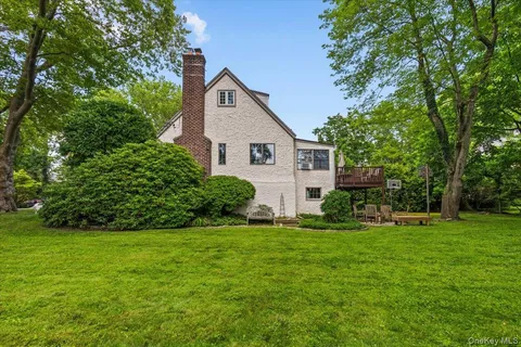 a front view of house with yard and green space