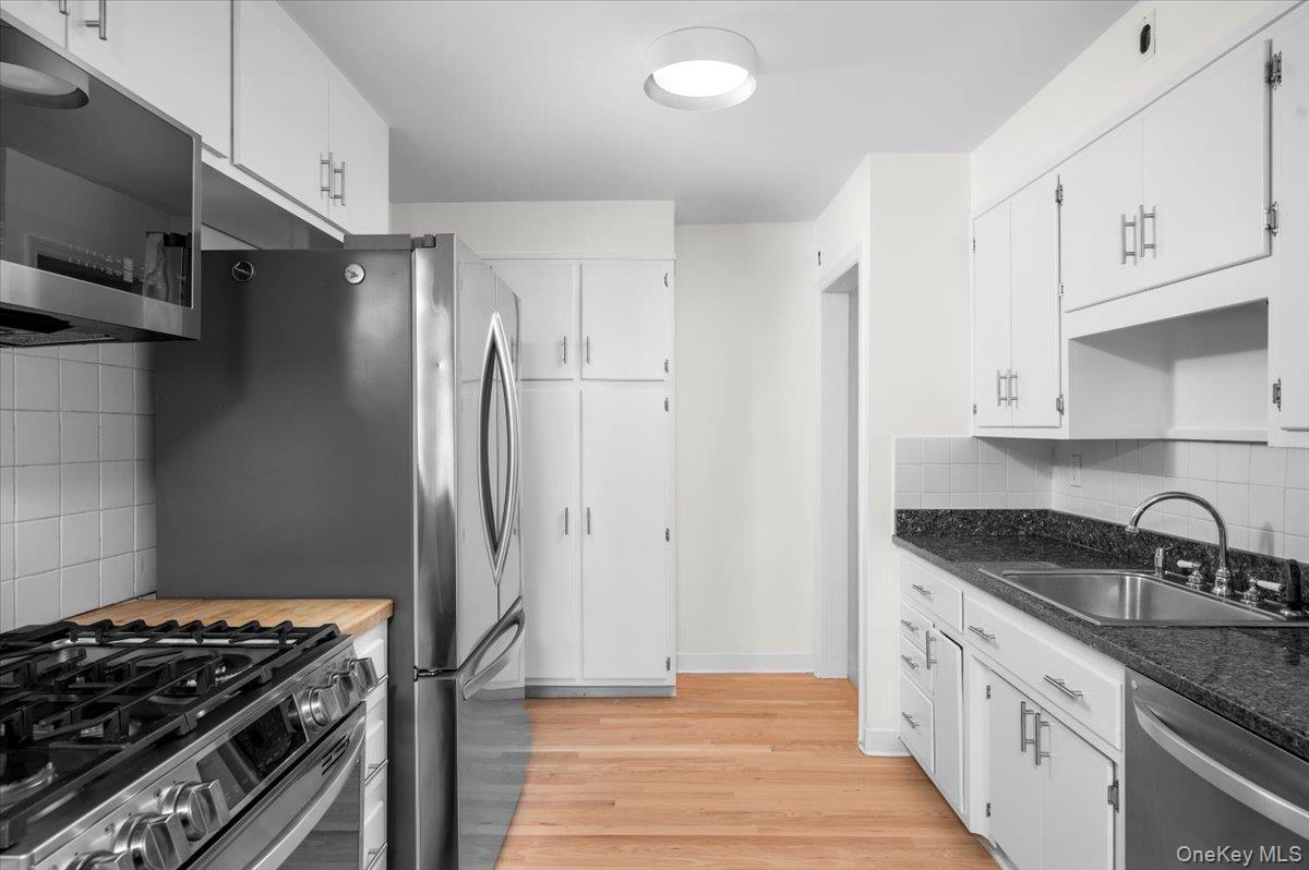 115 Coolidge Avenue Rye, NY 10580 - Photo 9 of 30 a kitchen with stainless steel appliances granite countertop a sink stove and refrigerator