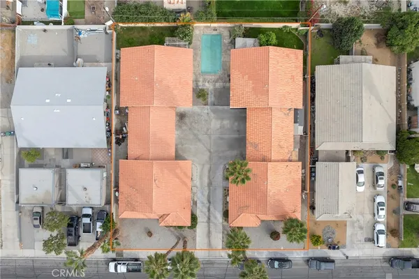an aerial view of residential houses with outdoor space and street view