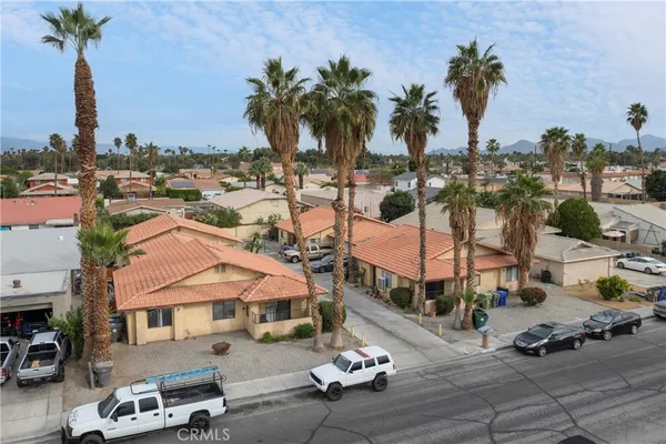 an aerial view of multiple houses with yard