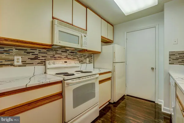 a kitchen with a stove and a refrigerator