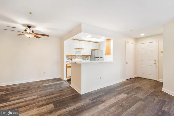 a view of a kitchen with a dishwasher and a white cabinets
