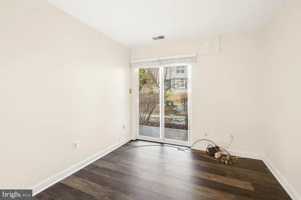 a view of a room with wooden floor and window