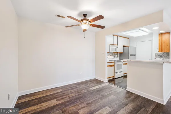 a view of kitchen with wooden floor and a window