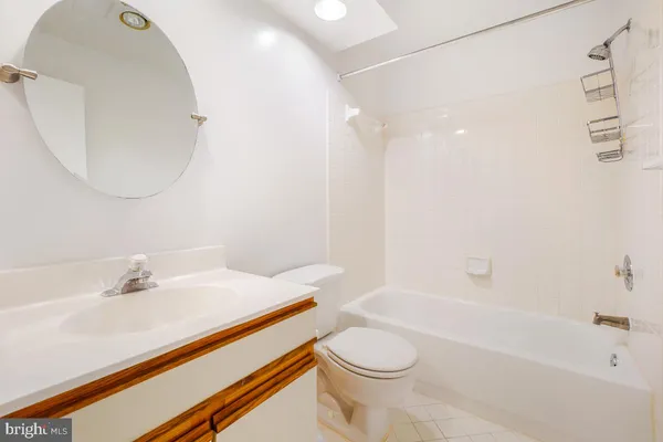 a bathroom with a sink a toilet and bathtub