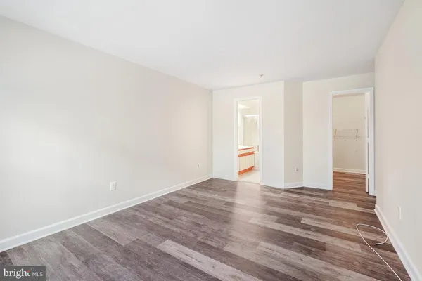 a view of an empty room and wooden floor