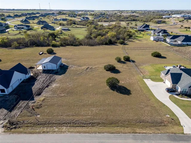 an aerial view of a building and ocean view