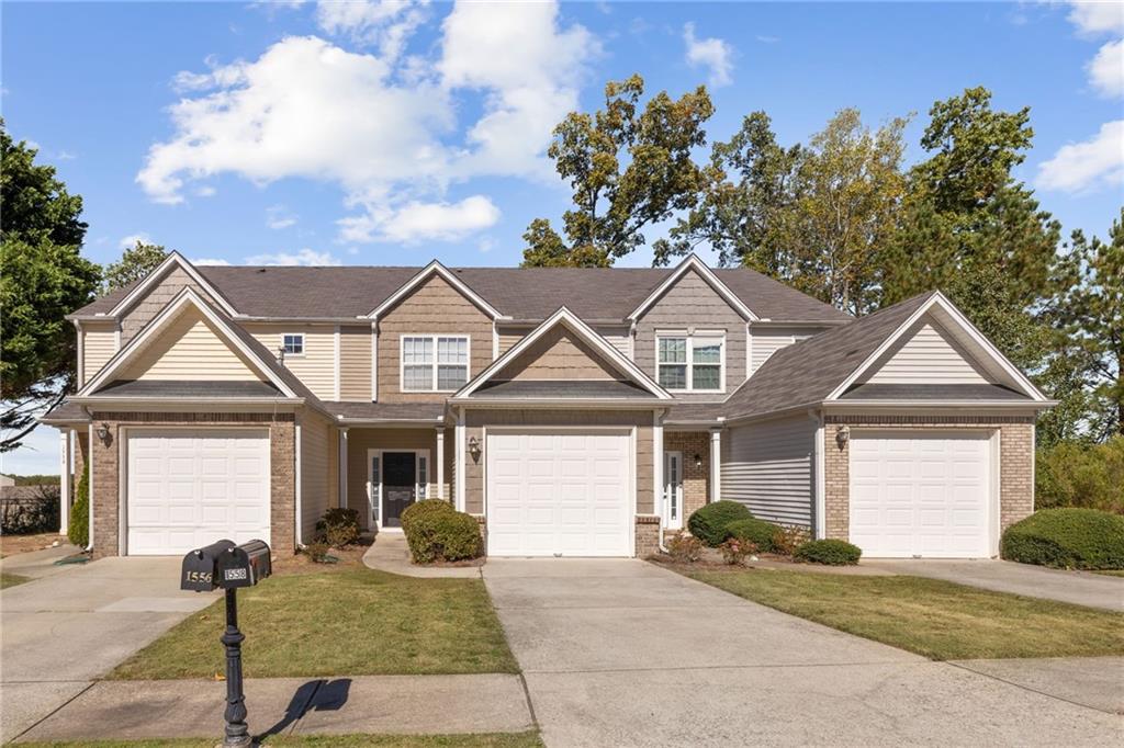 1558 Paramount View Trace Northeast Sugar Hill, GA 30518 - Photo 2 of 21 a front view of a house with garden