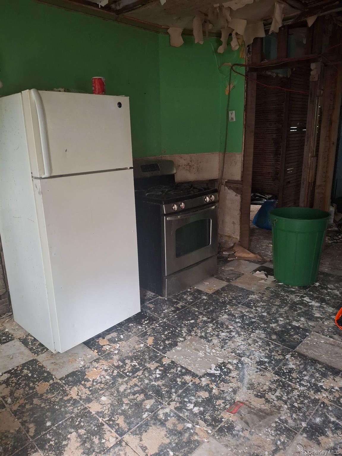 74 Elizabeth Street Amsterdam, NY 12010 - Photo 11 of 15 Kitchen featuring freestanding refrigerator and stainless steel gas stove
