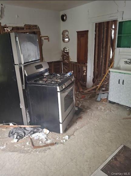 74 Elizabeth Street Amsterdam, NY 12010 - Photo 4 of 15 Kitchen featuring stainless steel gas range oven and freestanding refrigerator