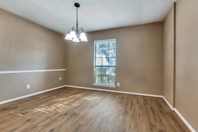 a view of wooden floor and windows in a room