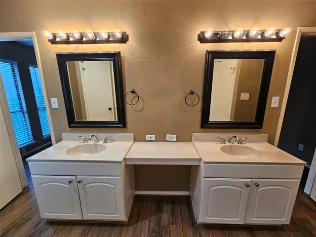 a bathroom with a double vanity sink and a mirror