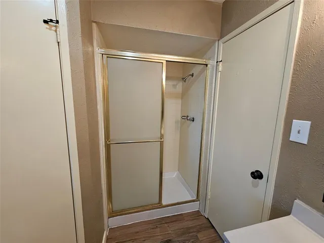 a bathroom with a glass shower door