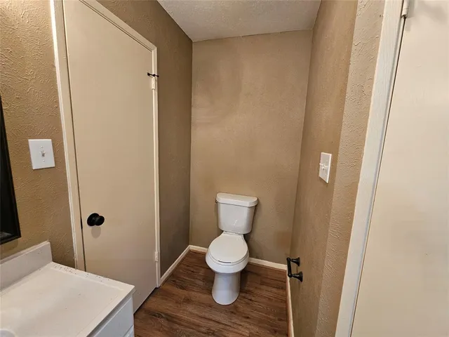 a white toilet sitting next to a bathroom sink
