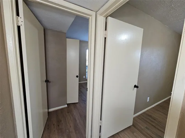 a view of hallway with wooden floor