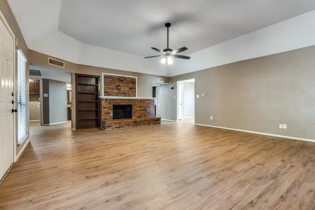 a view of livingroom with furniture chandelier fan and a fireplace