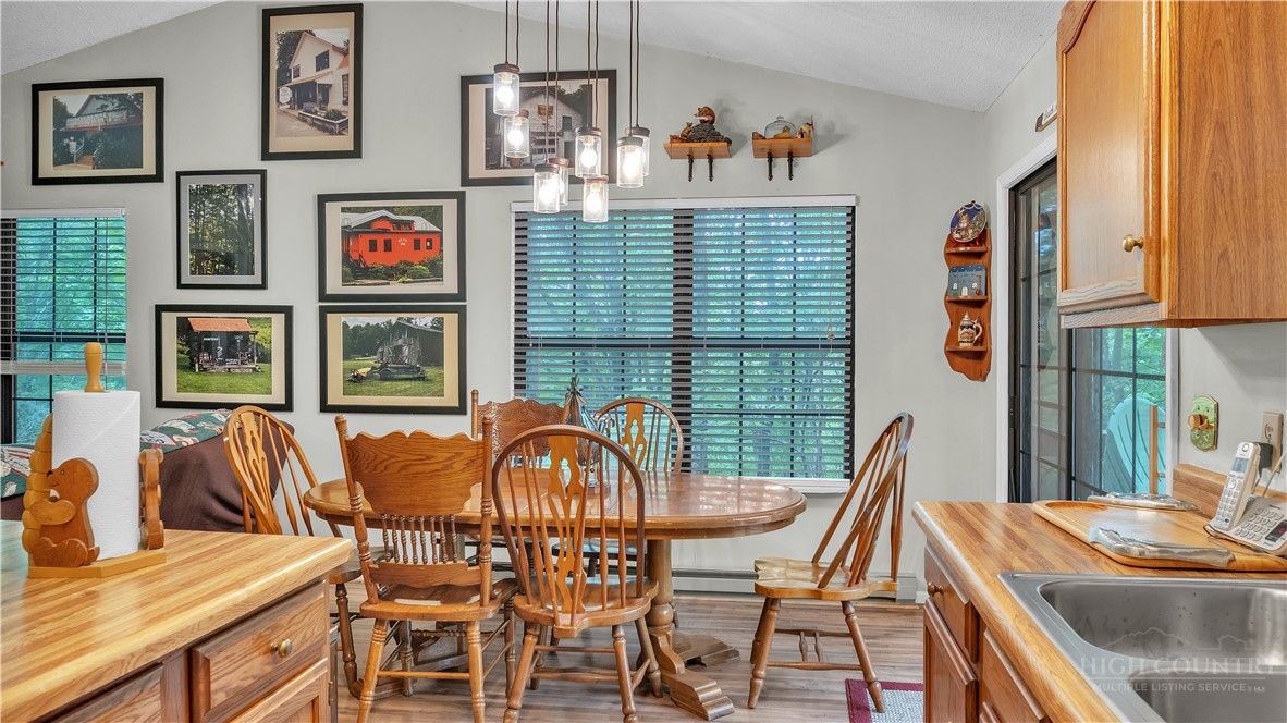 117 Rhododendron Drive Beech Mountain, NC 28604 - Photo 8 of 33 a view of a dining room with furniture window and outside view