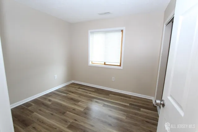 a view of wooden floor in an empty room