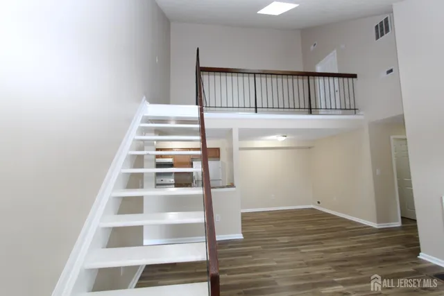 a view of a hallway with wooden floor and entryway