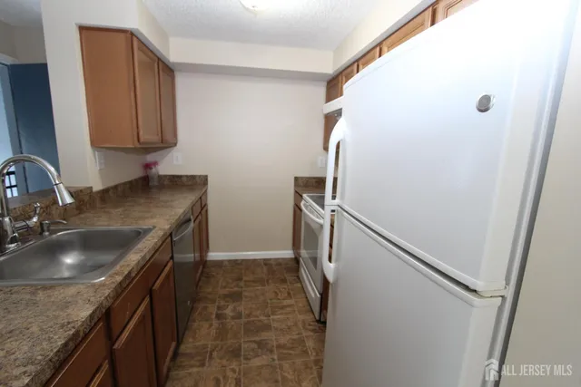 a white refrigerator freezer and a stove top oven