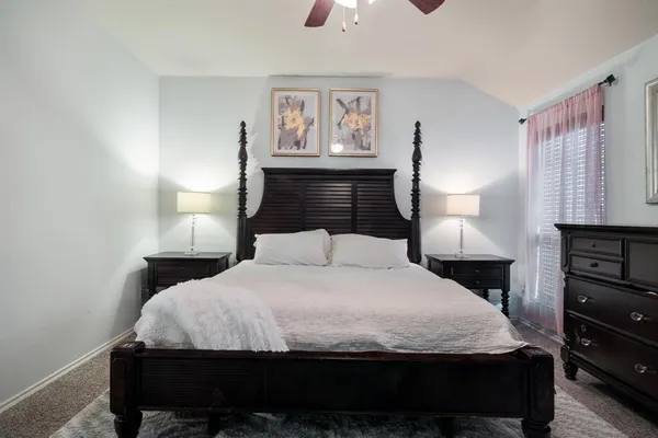 a bedroom with a bed and a night stand